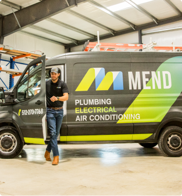 a technician steps out of a Mend work van in a warehouse